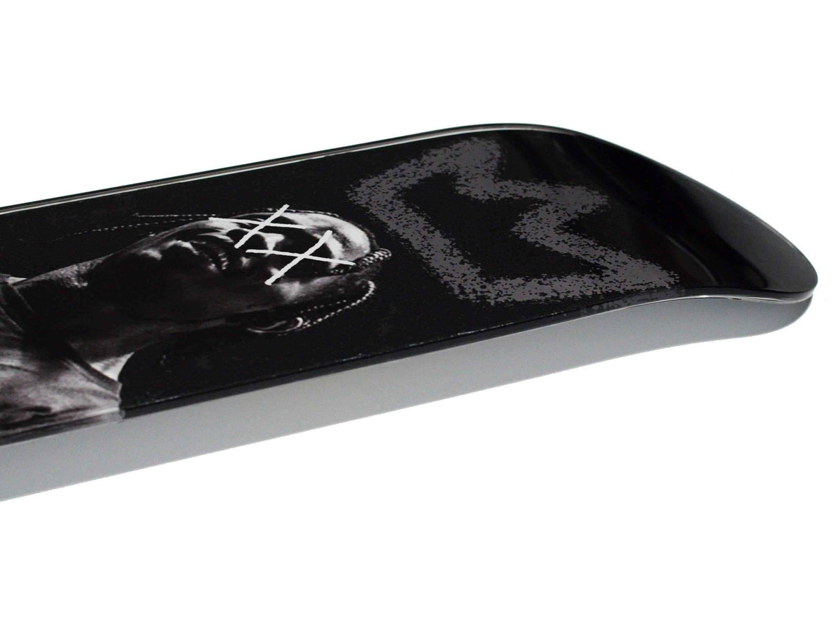 King Travis Skateboard displayed diagonally on white background.