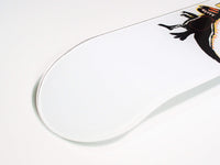 Skateboard resting against wall, showcasing dino design and grip tape on top