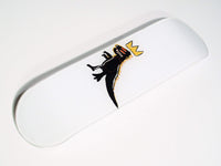 Side view of skateboard highlighting curved edges and dinosaur artwork