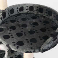 Multi-level beige cat tree showing climbing posts and lounging platforms in a cozy setup.