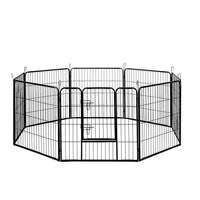 Black 8-panel pet playpen set up as an octagon on wooden floor, ideal for small dogs or puppies.