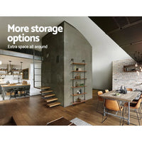 Industrial pipe shelf mounted with decorative objects and books, demonstrating its storage use.