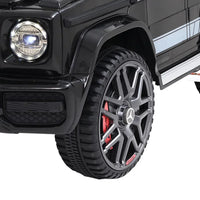 Open door view of black Mercedes-Benz AMG G63 kids ride on car revealing seat interior