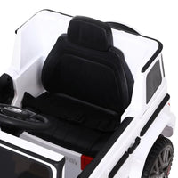 White kids ride-on AMG G63 electric car angled view highlighting design and suspension