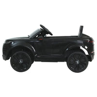Close-up of black kids electric ride on car’s steering wheel and dashboard details.