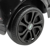 Black kids ride on Land Rover Evoque electric car front with open door and visible seat.