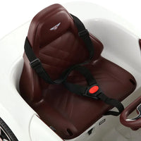 Interior view showcasing dashboard and steering wheel of white Bentley electric ride on toy.
