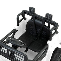 Rear view of white electric kids ride on jeep highlighting taillights and seat.
