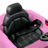 Close-up of front grille and headlights on pink ride-on electric car.