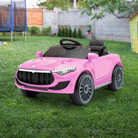 Pink ride-on car with remote control placed on a tiled floor indoors.