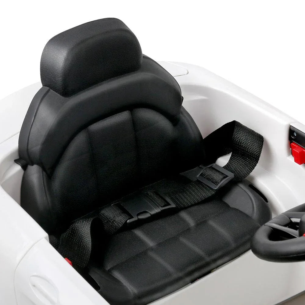 Interior shot of kids ride on car featuring detailed dashboard and steering wheel.
