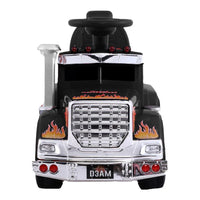 Close-up of black kids’ electric truck dashboard and control panel with steering wheel.