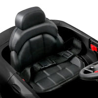 Top view of black electric ride-on car highlighting shiny lacquer finish and interior.