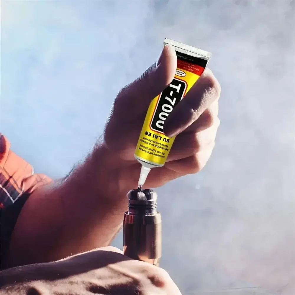 Three black and yellow tubes of multipurpose adhesive glue in different sizes arranged on a white background.