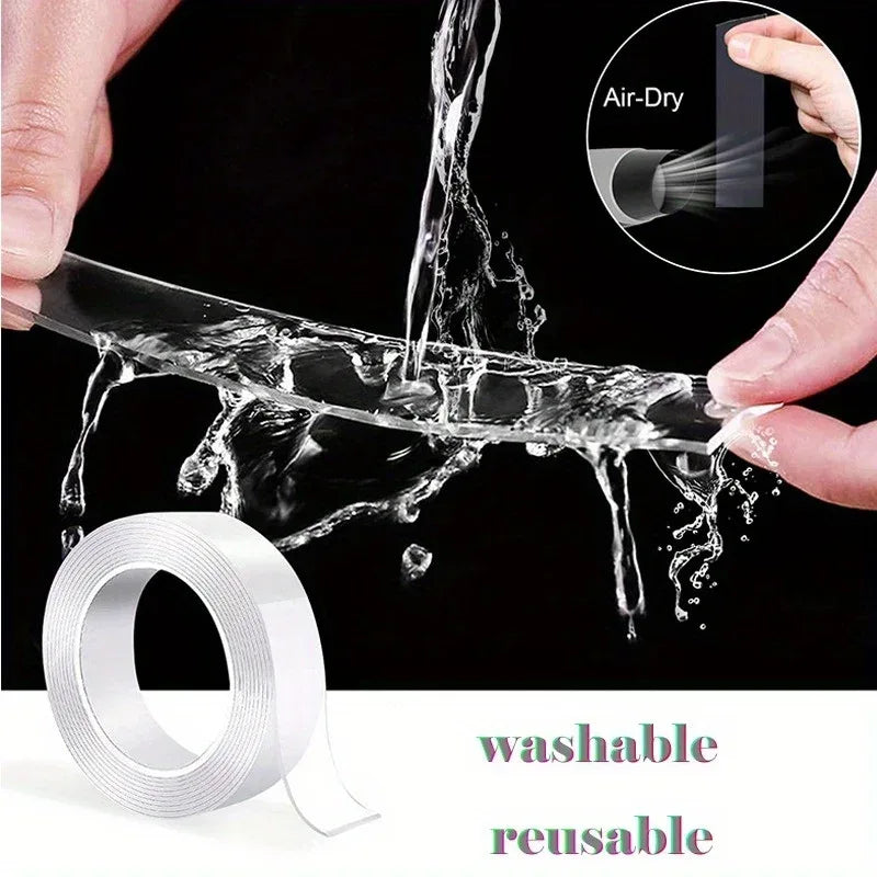 A roll of transparent double-sided adhesive tape unrolled on a clean white surface.