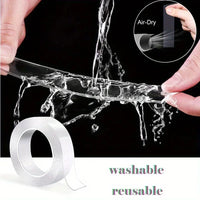 A roll of transparent double-sided adhesive tape unrolled on a clean white surface.