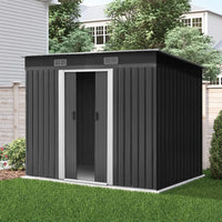 The entire garden shed assembled on flat outdoor ground with large double doors and vents.