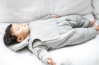 Close-up detail of the fleece lining and fabric texture of gray baby jumpsuit.