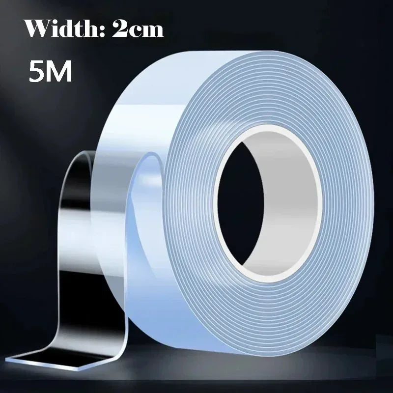 A clear roll of double-sided adhesive tape sits on a white surface, highlighting its transparent appearance.