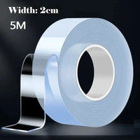 A clear roll of double-sided adhesive tape sits on a white surface, highlighting its transparent appearance.