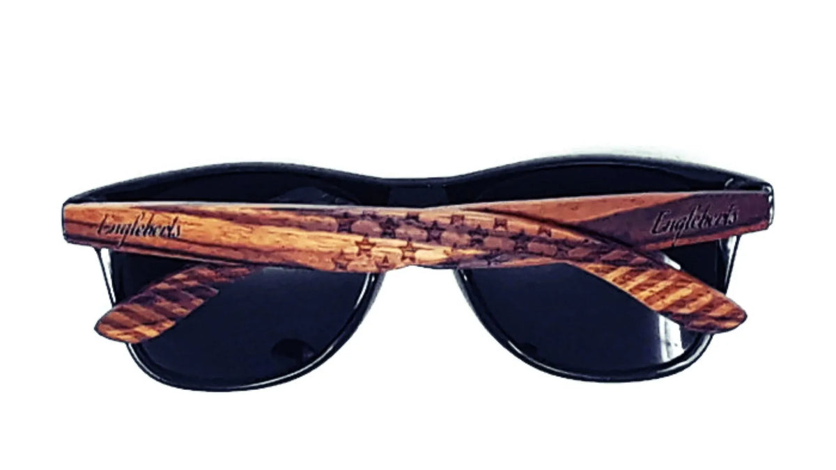Back view of wooden sunglass arms featuring engraved stars and stripes pattern.