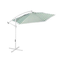 Green and white striped outdoor umbrella providing shade on a garden patio under clear sky.