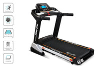 Full electric treadmill setup in a home gym environment with wooden floor