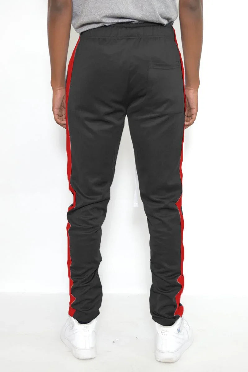 Back view of men's slim fit black track pants showing stripe detail and elastic waistband.