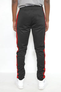 Back view of men's slim fit black track pants showing stripe detail and elastic waistband.