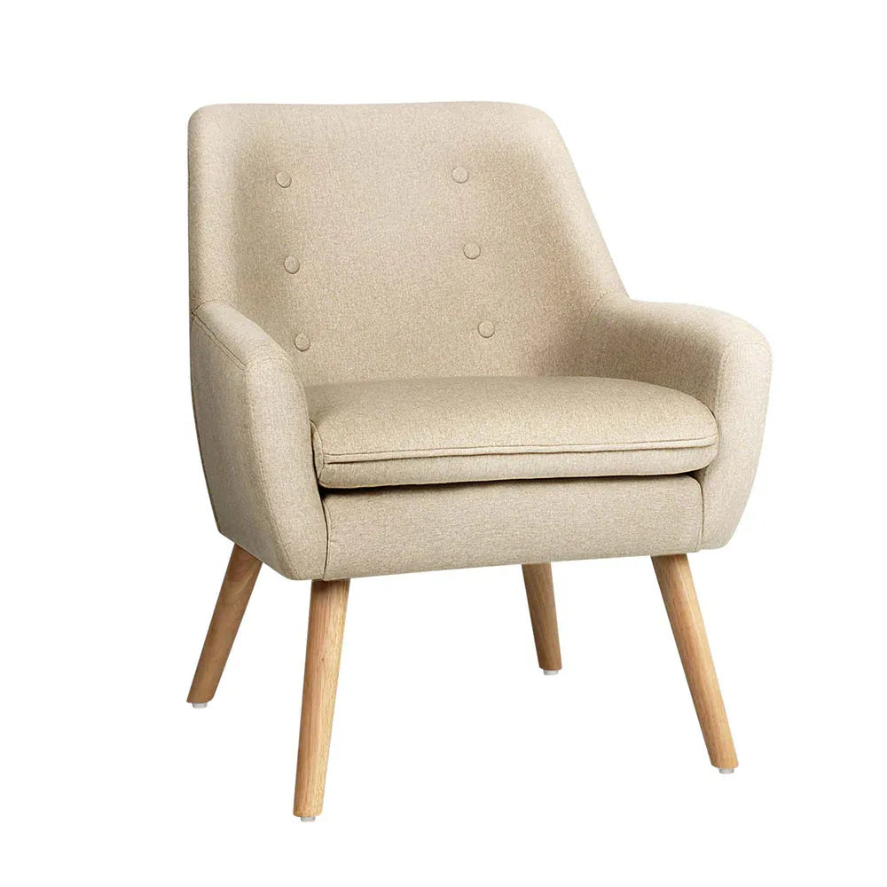 Beige fabric dining armchair with tufted button backrest and wooden tapered legs, angled view.