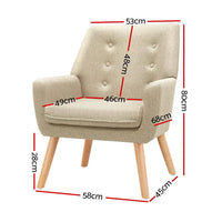Side profile of beige fabric armchair showing padded armrests and sturdy wooden legs.