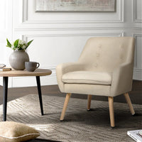 Beige fabric armchair photographed from a low angle against a neutral background.