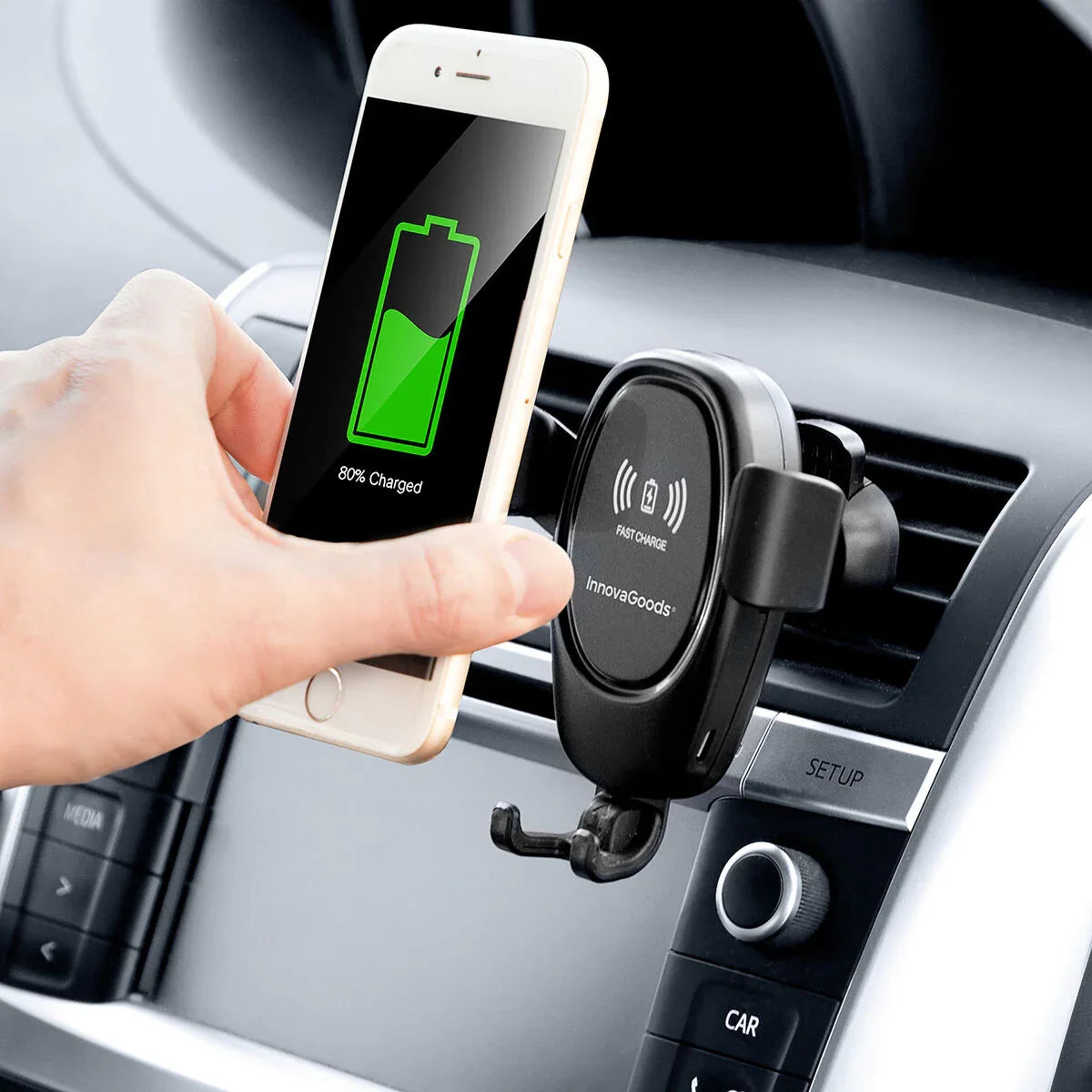 Mobile phone holder installed in car interior with wireless charging function, device displayed.