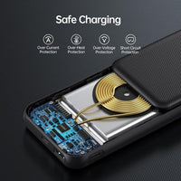 Black wireless power bank next to a charging cable and smartphone on a table.