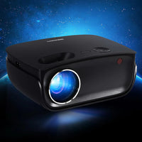 Devanti mini projector projecting bright colorful image on white wall in living room.