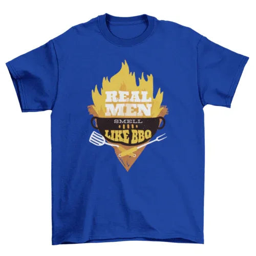 Man wearing black 'Real Men' BBQ graphic T-shirt, standing against a neutral background.