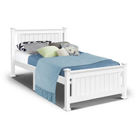 White single size wooden bed frame with a simple headboard in a bright, minimal room.