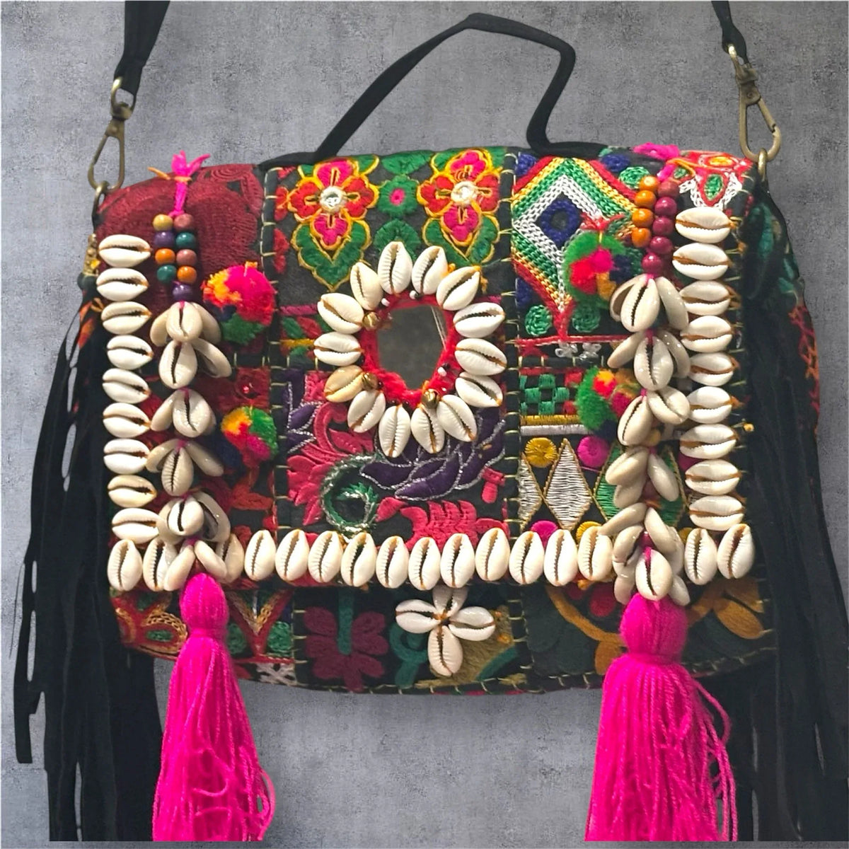 Banjara Boho Sling Bag angled side showing colorful tribal embroidery and shell decorations.