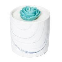 Hand-painted ceramic candle vessel with natural white marble pattern, empty and showcased on white background.
