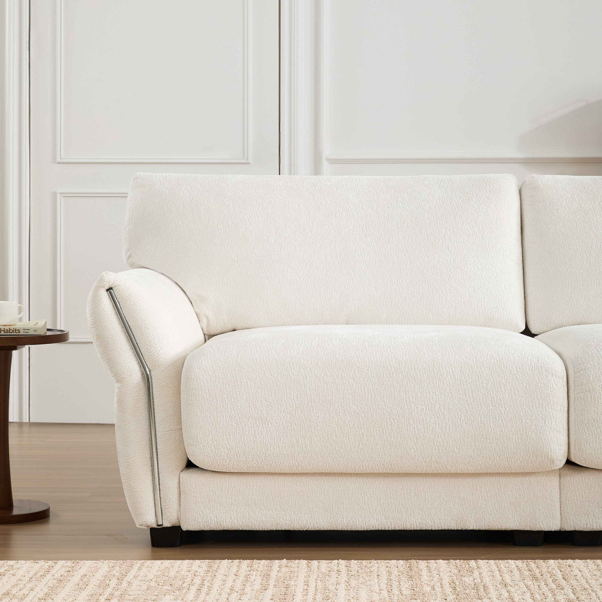 White L-shaped sectional sofa with extra-wide seat cushions and built-in USB charging port, seating for four.