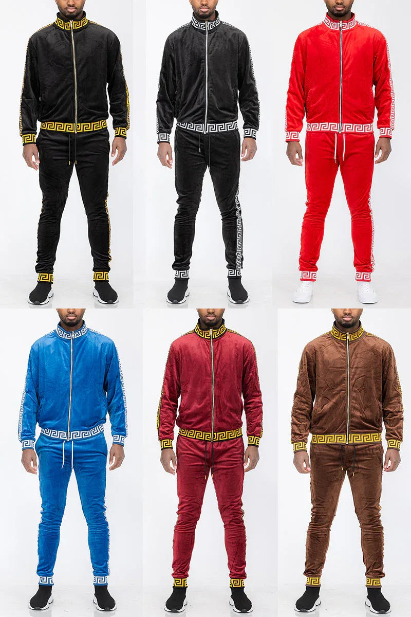 Male model wearing full zip status velour track jacket and matching pants, standing against a neutral background.