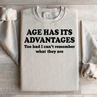 Peach sweatshirt displayed flat with prominent white "Age Has Its Advantages" lettering.