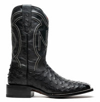 Front angled view of black cowboy boot with ostrich skin on vamp and square toe.
