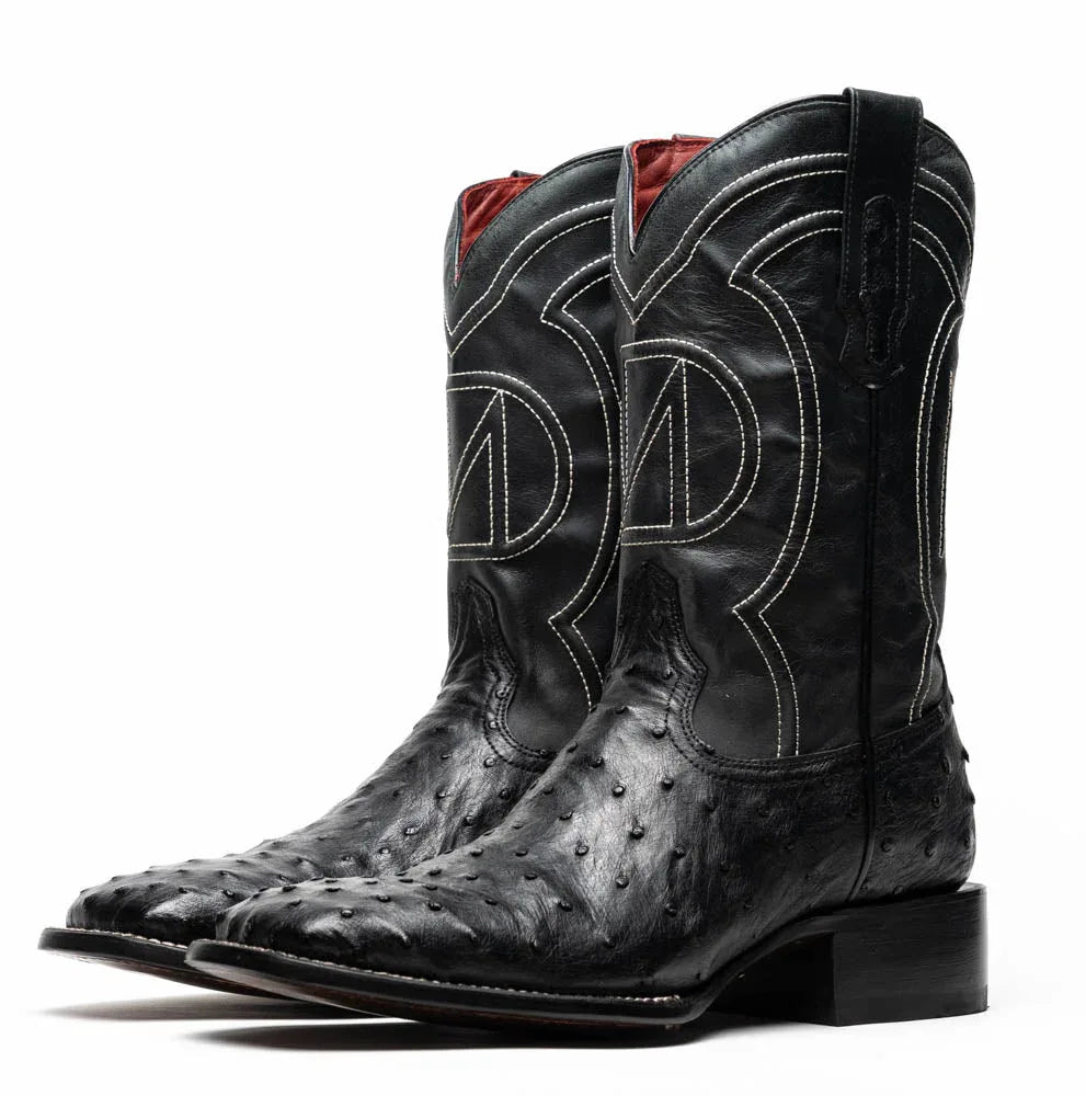 Side view of premium black ostrich skin cowboy boot highlighting red leather interior.