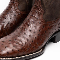 Brown ostrich leather cowboy boot angled to show smooth shaft and textured vamp