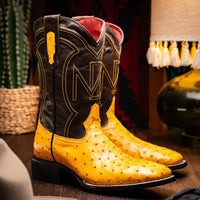 Lifestyle image of Alabama Buttercup boot worn outdoors on rustic wooden floor.