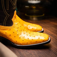 Alabama Buttercup ostrich leather cowboy boot styled with denim in casual setting.
