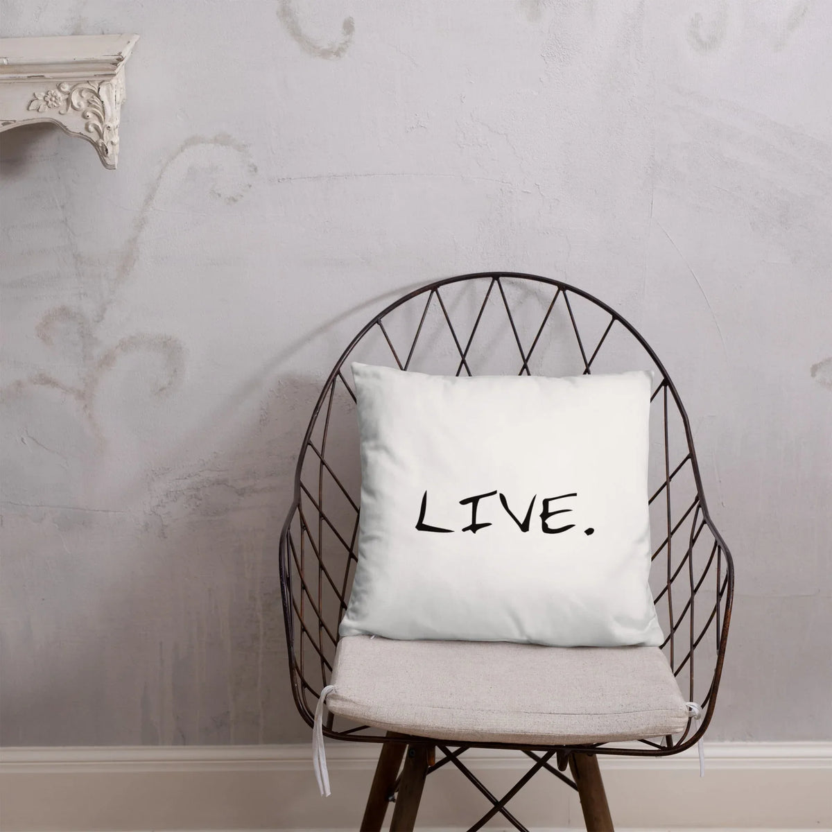 White pillow placed on dark sofa with light walls in a cozy living room