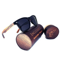 Zebrawood sunglasses with stars and stripes design displayed alongside wooden bamboo case and accessories