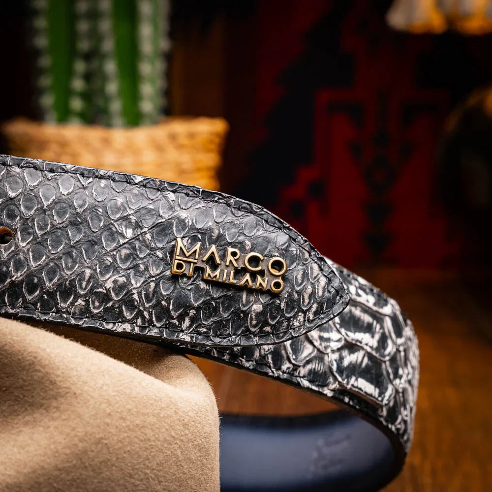 Man styling ARKANSAS python belt on casual outfit highlighting western antique brass buckle.